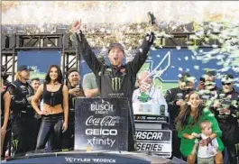  ?? STEPHEN SPILLMAN AP ?? Tyler Reddick celebrates after winning the NASCAR Cup Series race at Circuit of the Americas road course despite late slowdowns on Sunday in Austin, Texas.