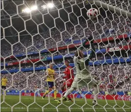  ?? Frank Augstein ?? The Associated Press England midfielder Dele Alli, second right, scores his side’s second goal off a set piece in a 2-0 World Cup quarterfin­al victory over Sweden on Saturday in Samara, Russia.