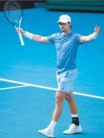  ?? DANIEL POCKETT/GETTY ?? J.J. Wolf celebrates match point during his match against Michael Mmoh at the Australian Open on Saturday at Melbourne Park in Melbourne, Australia.