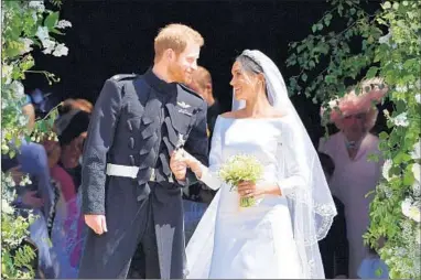  ?? BEN STANSALL/GETTY-AFP ?? Prince Harry and Meghan Markle, the Duchess of Sussex, emerge Saturday from St. George’s Chapel at Windsor Castle.