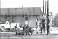  ?? TEHACHAPI NEWS PHOTO COURTESY OF HENSON FAMILY ?? ABOVE: Community members assist Kelly Henson, one of the twin sisters injured in a 1972 traffic accident in downtown Tehachapi. The accident took place in front of the Tehachapi Depot. LEFT: Tracy Henson, one of the twin sisters injured, is pictured here being loaded into an ambulance.