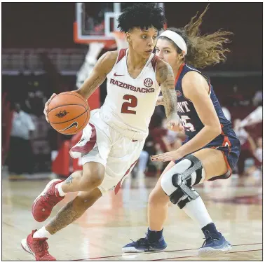  ?? NWA Democrat-Gazette/ANDY SHUPE ?? Arkansas guard Alexis Tolefree (2) drives Wednesday past Belmont guard Grace Smith during the first half of play in Bud Walton Arena. Visit nwadg.com/photos to see more photograph­s from the game.