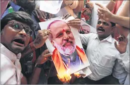  ?? –PIC: BL SONI ?? Members of the Indian Youth Congress burn a photograph of BJP leader Jay Bhagwan Goyal during a protest against his book 'Aaj Ke Shivaji: Narendra Modi', in Mumbai on Monday.