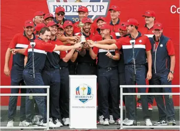  ?? ?? Star-spangled joy: Team usa celebrate with the ryder Cup after defeating Team europe 19 to 9 at Whistling straits on sunday. — afp