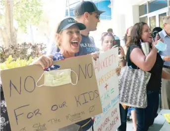  ?? MARTA LAVANDIER/AP ?? A small but vocal group, including Joann Marcus of Fort Lauderdale (left), spoke vehemently against masks in schools on Wednesday at an emergency meeting of the Broward County School Board.