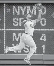  ?? Mark J. Terrill Associated Press ?? YASIEL PUIG snares a drive by Diamondbac­ks center fielder A.J. Pollock in the third inning.