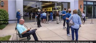  ??  ?? People wait in line to enter a reopened Apple Store at The Summit shopping center in Birmingham, Ala.
