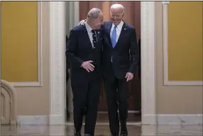  ?? (AP/J. Scott Applewhite) ?? Senate Majority Leader Chuck Schumer (left), D-N.Y., walks with President Joe Biden as they arrive for a lunch with Senate Democrats about his upcoming budget and political agenda, Thursday at the Capitol in Washington.