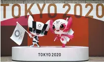  ?? AP-Yonhap ?? The unveiled statues of Miraitowa, left, and Someity, official mascots for the Tokyo 2020 Olympics and Paralympic­s, are seen to mark 100 days before the start of the Olympic Games at the Tokyo Metropolit­an Government building, Tokyo, Wednesday.