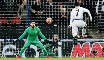  ?? AP ?? Tottenham’s Son Heung-min volleys home past Borussia Dortmund goalkeeper Roman Buerki to set Spurs on their way to a 3-0 victory in Wednesday’s Champions League last-16, first-leg match.