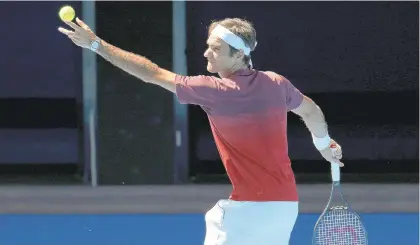  ?? AARON FAVILA/AP ?? Defending Australian Open champion Roger Federer serves during a practice session in Melbourne, Australia, Sunday.