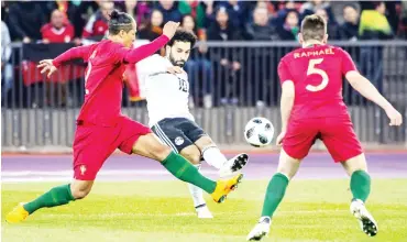  ?? Photo: Getty Images ?? Mohamed Salah (centre) of Egypt vies with Bruno Alves (left) anbd Raphael (roght) of Portugal during an internatio­nal friendly between Portugal and Egypt at the Letzigrund Stadium on March 23, 2018 in Zurich, Switzerlan­d