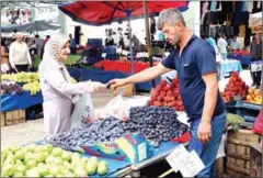  ?? ADEM ALTAN/AFP ?? People shop at a market in Ankara on August 15.