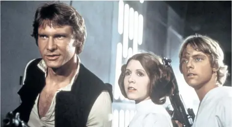  ?? THE CANADIAN PRESS ?? From left: Harrison Ford, Carrie Fisher, and Mark Hamill are seen in a scene from Star Wars.
