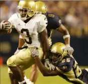  ?? Matt Freed/Post-Gazette ?? Pitt’s Darelle Revis, right, tries to drag down Notre Dame’s Darius Walker in the 2005 “GameDay” game. It wasn’t as much fun as 2003.