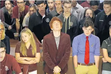  ?? SUSAN STOCKER/STAFF PHOTOGRAPH­ER ?? Jaclyn Corin, Ryan Deitsch and Alfonso Calderon, along with their classmates from Marjory Stoneman Douglas High School, listen as fellow student Lorenzo Prado speaks at a news conference in Tallahasse­e.