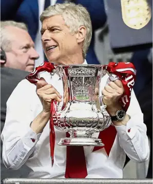  ??  ?? My saving grace: Arsenal manager Arsene Wenger with the English FA Cup trophy after his side beat Chelsea in the final on May 27.