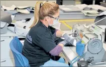  ?? COURTESY AIS INC. ?? AIS Inc. team member Neida Ortiz works on sewing a mask earlier this year for use in the medical industry. The Leominster office furniture manufactur­er started a ‘Sew The Masks’ program for health care workers and first responders and is now making masks for any election workers in the state who needs one.