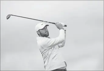  ?? Aaron Doster/USA TODAY Sports ?? Scottie Scheffler plays his shot from the fairway on the 18th hole during the final round of the RBC Heritage golf tournament. Play was suspended on Sunday, due to inclement weather on Monday.