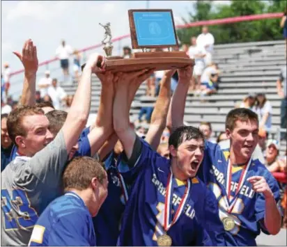  ?? PETE BANNAN — DIGITAL FIRST MEDIA ?? Springfiel­d captains hold the trophy after the Cougars defeated La Salle, 4-3, game Saturday at West Chester East. in the PIAA championsh­ip