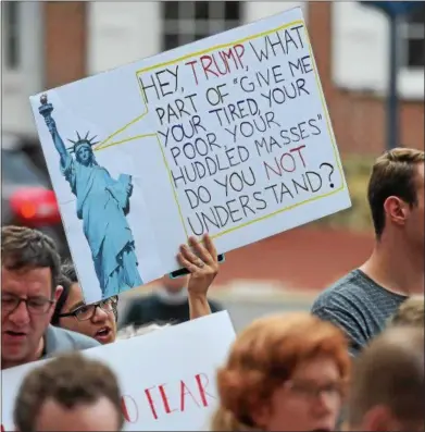  ?? PETE BANNAN – DIGITAL FIRST MEDIA ?? A protestor on the steps of the historical Chester County Courthouse takes part in rally protesting the Trump administra­tion’s immigratio­n policies and in support local immigrant communitie­s Sunday night in West Chester.