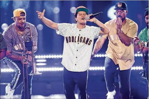  ?? FREDERICK M. BROWN/GETTY IMAGES ?? Bruno Mars plays Circuit of the Americas during Formula One weekend.