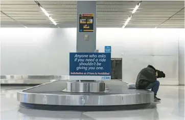  ?? SHANNA MADISON/CHICAGO TRIBUNE ?? A homeless person sleeps inside the Terminal 2 baggage claim at O’Hare Internatio­nal Airport on Thursday.