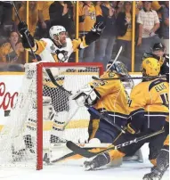  ??  ?? Pittsburgh’s Patric Hornqvist celebrates after scoring against Nashville goaltender Pekka Rinne with 1:35 to go in the game.