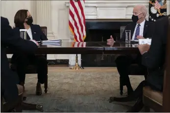  ?? EVAN VUCCI — THE ASSOCIATED PRESS ?? President Joe Biden speaks with Vice President Kamala Harris about the southern border during a meeting in the State Dining Room of the White House in Washington on Wednesday.