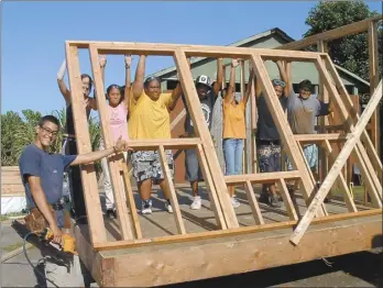  ?? Photos courtesy Rick Rutiz and Kirsten Whatley ?? Students work together on a building in 2004. One of the students, 16-year-old James Freudenber­gPu (far left), has gone on to become the manager of Ma Ka Hana Ka ‘Ike’s building program.