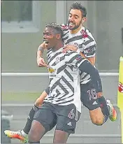  ??  ?? Manchester United's Paul Pogba (left) celebrates with teammate Bruno Fernandes after his goal against AC Milan on Thursday.