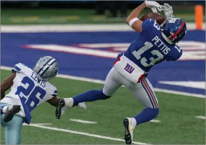  ?? RICH HUNDLEY III — FOR THE TRENTONIAN ?? Giants receiver Dante Pettis (13) hauls in a catch as Cowboys defensive back Jourdan Lewis (29) tries to break up the pass during Sunday afternoon’s game at MetLife Stadium in East Rutherford.