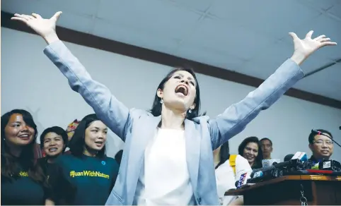  ?? (Erik de Castro/Reuters) ?? REGINA LOPEZ sings during a news conference in Manila yesterday, shortly after lawmakers ousted her as environmen­t secretary, 10 months into her term.