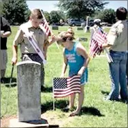  ?? Photo submitted ?? Josh Robinson Jr. and his sister Kelly Robinson helped place flags at the graves of veterans on Sunday ahead of Memorial Day.