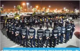  ??  ?? KUWAIT: Policemen gather during a security campaign in Jleeb Al-Shuyoukh late Monday. -—MoI