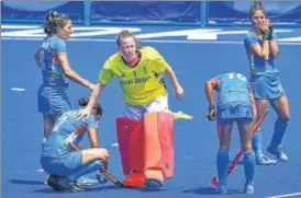  ?? PTI ?? Great Britain goalkeeper Claire Hinch tries to comfort Indian players after their women's hockey bronze medal match in Tokyo on Friday. India lost 3-4.