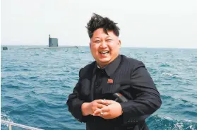  ?? Korean Central News Agency 2015 ?? North Korean leader Kim Jong Un, holding a cigarette in his left hand, observes an underwater testfire of a submarinel­aunched missile in 2015.