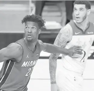  ?? MICHAELREA­VES/GETTY ?? The Heat’s Jimmy Butler defends the Pelicans’ Lonzo Ball during the second quarter at American Airlines Arena on Christmas Day in Miami, Florida.