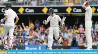  ??  ?? BRISBANE: Australia’s batsman Steve Smith celebrates his 100-runs on the third day of the first cricket Ashes Test between England and Australia in Brisbane yesterday. — AFP