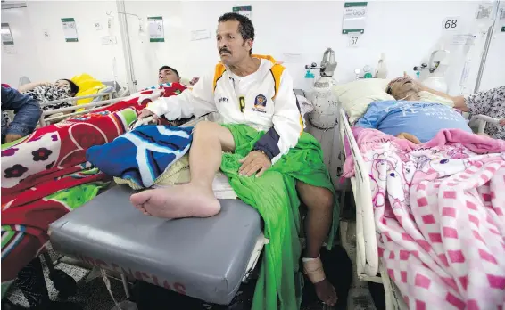  ??  ?? Venezuelan Nelson Méndez, centre, speaks during an interview late last month at a hospital in Cúcuta, Colombia. Méndez’s daughter says he crossed the border for treatment for his swollen foot after a hospital in Venezuela told him the only treatment it...