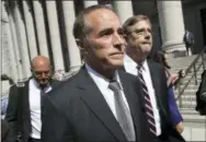  ?? MARY ALTAFFER—THE ASSOCIATED PRESS ?? Republican U.S. Rep. Christophe­r Collins, center, leaves federal court, Wednesday, in New York. Rep. Collins of western New York state has been indicted on charges that he used inside informatio­n about a biotechnol­ogy company to make illicit stock trades