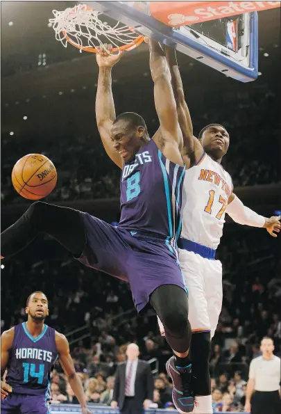  ?? — THE ASSOCIATED PRESS ?? Bismack Biyombo of the Charlotte Hornets dunks the ball in front of Cleanthony Early of the New York Knicks in the Hornets’ 110-82 win over the hapless Knicks on Saturday.