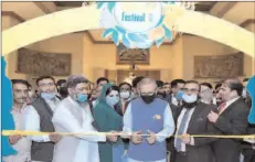  ??  ?? ISLAMABAD
President Dr Arif Alvi inaugurati­ng the Mango Festival, held at Aiwan-e-Sadr.
-APP