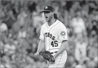  ?? DAVID J. PHILLIP/AP PHOTO ?? Houston Astros starting pitcher Gerrit Cole (45) reacts after striking out Jose Ramirez of the Cleveland Indians to end the sixth inning of Game 2 of the American League Division Series on Saturday at Houston.