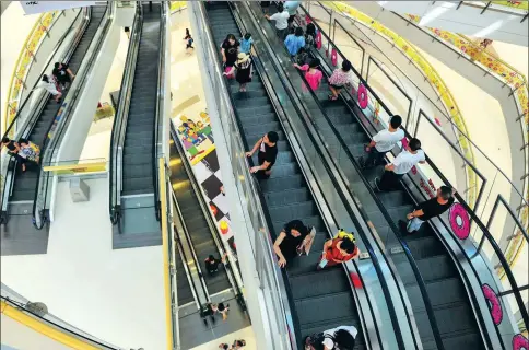  ?? PROVIDED TO CHINA DAILY ?? Shoppers travel on escalators in a mall in Shenyang, Liaoning province.