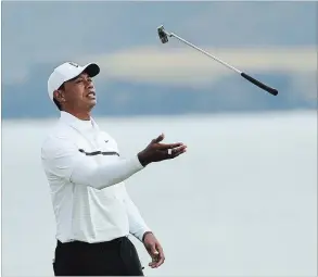  ?? PETER MORRISON THE ASSOCIATED PRESS ?? Tiger Woods throws his club in the air on the 5th green during the second round of the British Open Golf Championsh­ips at Royal Portrush in Northern Ireland, Friday, July 19, 2019.