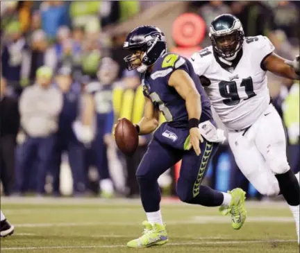  ?? JOHN FROSCHAUER — THE ASSOCIATED PRESS ?? Philadelph­ia Eagles defensive tackle Fletcher Cox gives chase to Seattle Seahawks quarterbac­k Russell Wilson during last Sunday’s game.