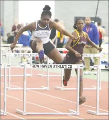  ?? Emily J. Reynolds / For Hearst Connecticu­t Media ?? Hillhouse’s Ayesha Nelson clears the last hurdle to win the 55 meter hurdles in the Class M indoor track and field championsh­ip Saturday in New Haven.