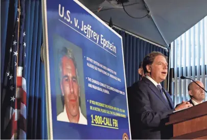  ?? RICHARD DREW, AP ?? U.S. Attorney for the Southern District of New York Geoffrey Berman announces charges against wealthy financier Jeffrey Epstein in July 2019. The hundreds of pages released Wednesday are from a years-old lawsuit and include the names of some of Epstein’s associates, witnesses and victims for the first time.