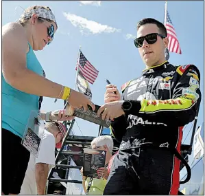  ?? AP/CHARLES KRUPA ?? NASCAR Monster Energy Cup driver Alex Bowman signs an autograph for a fan Saturday at New Hampshire Motor Speedway in Loudon, N.H. After breaking a drive shaft on his qualifying lap Friday, Bowman crashed his backup car in practice Saturday. He will drive Hendrick Motorsport­s teammate Jimmie Johnson’s spare car in today’s race.